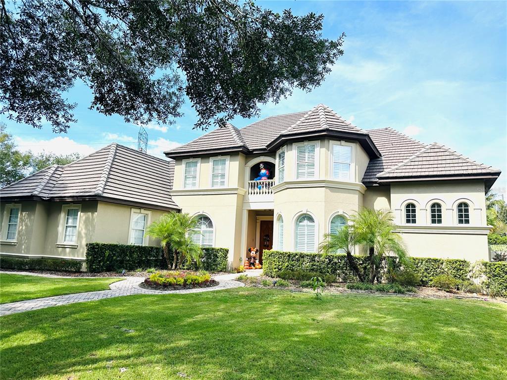 a front view of a house with a garden and plants