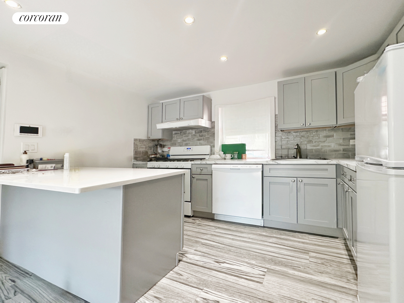 a kitchen with white cabinets sink and white appliances