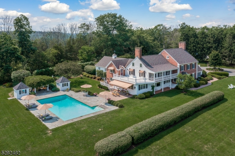 an aerial view of a house with swimming pool patio and outdoor seating