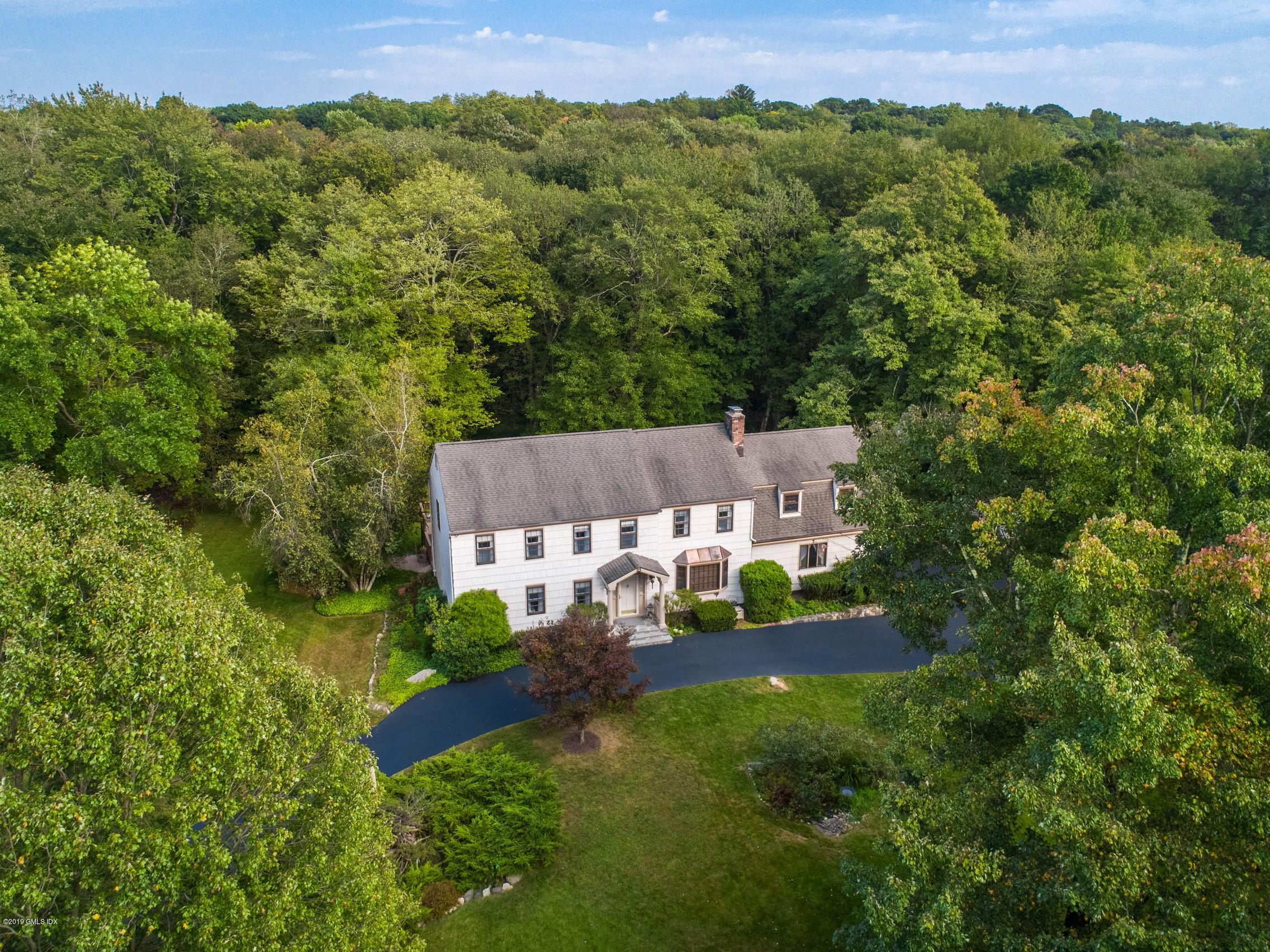 an aerial view of a house with yard