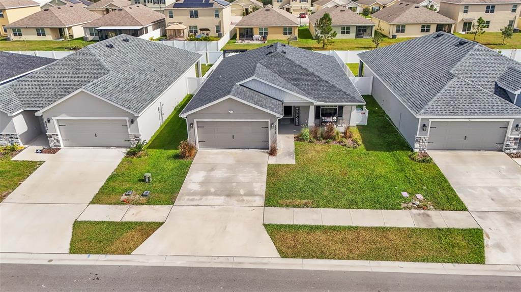 an aerial view of a house with a yard