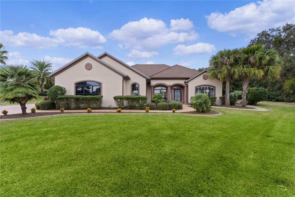 a front view of house with yard and green space