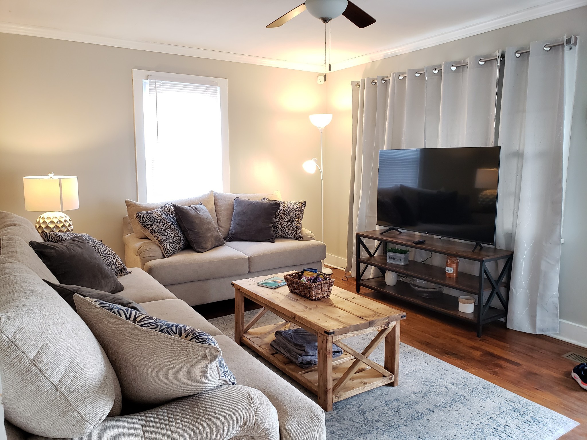 a living room with furniture and a flat screen tv