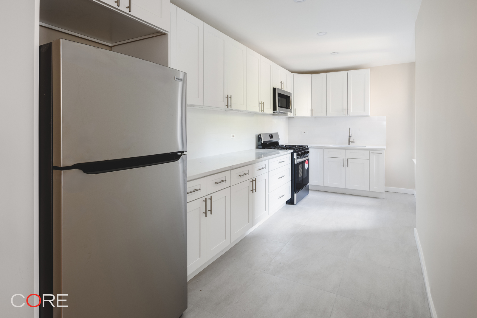 a kitchen with white cabinets and white appliances