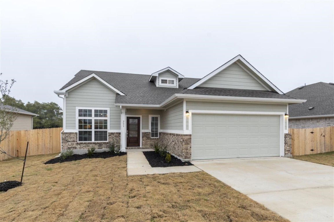 a view of a house with a yard and garage