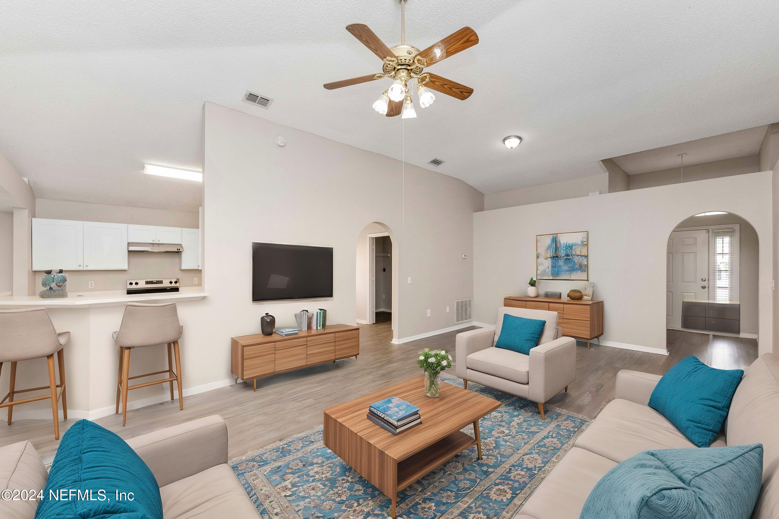 a living room with furniture and a flat screen tv