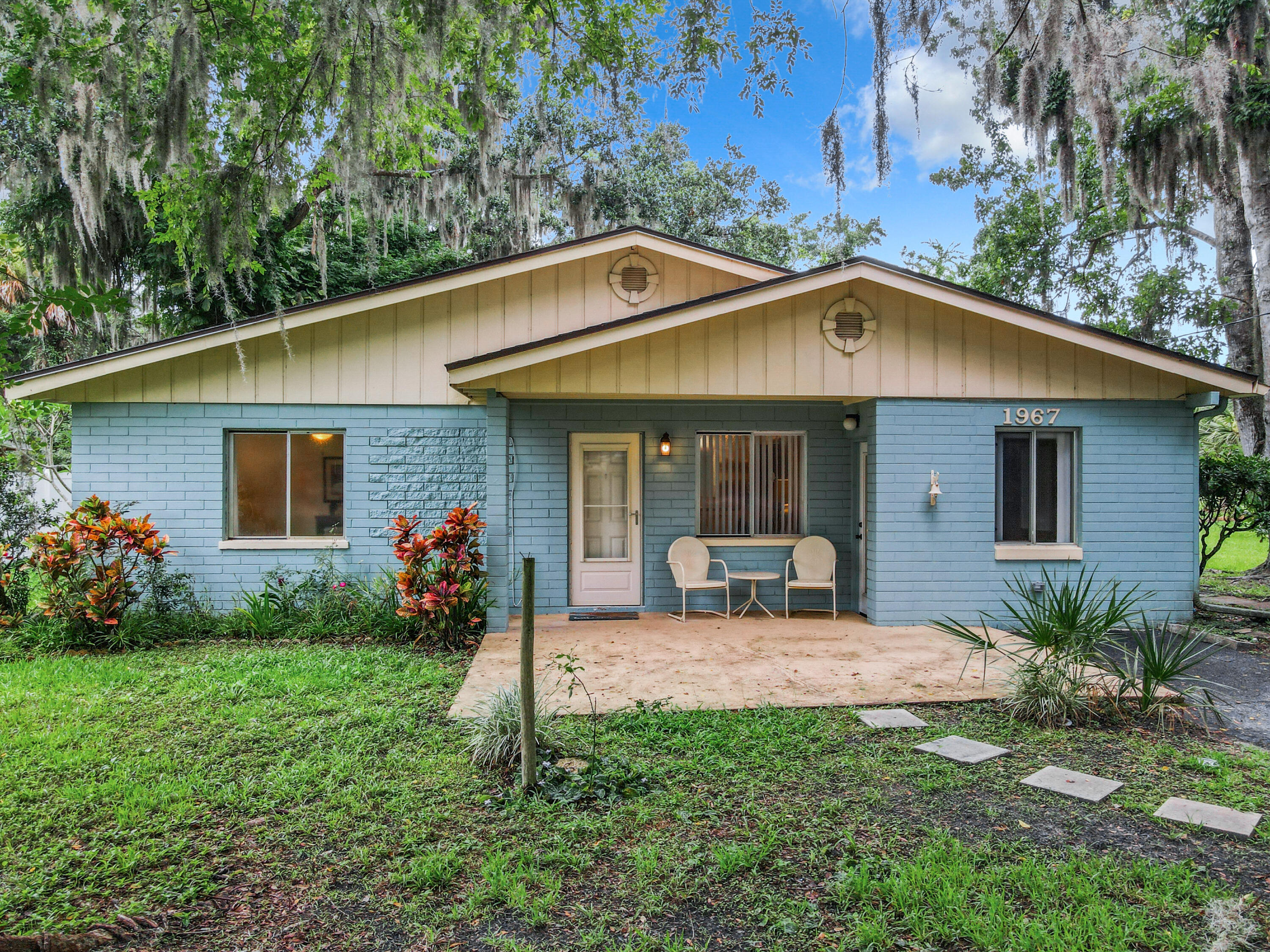 a front view of house with yard and outdoor seating