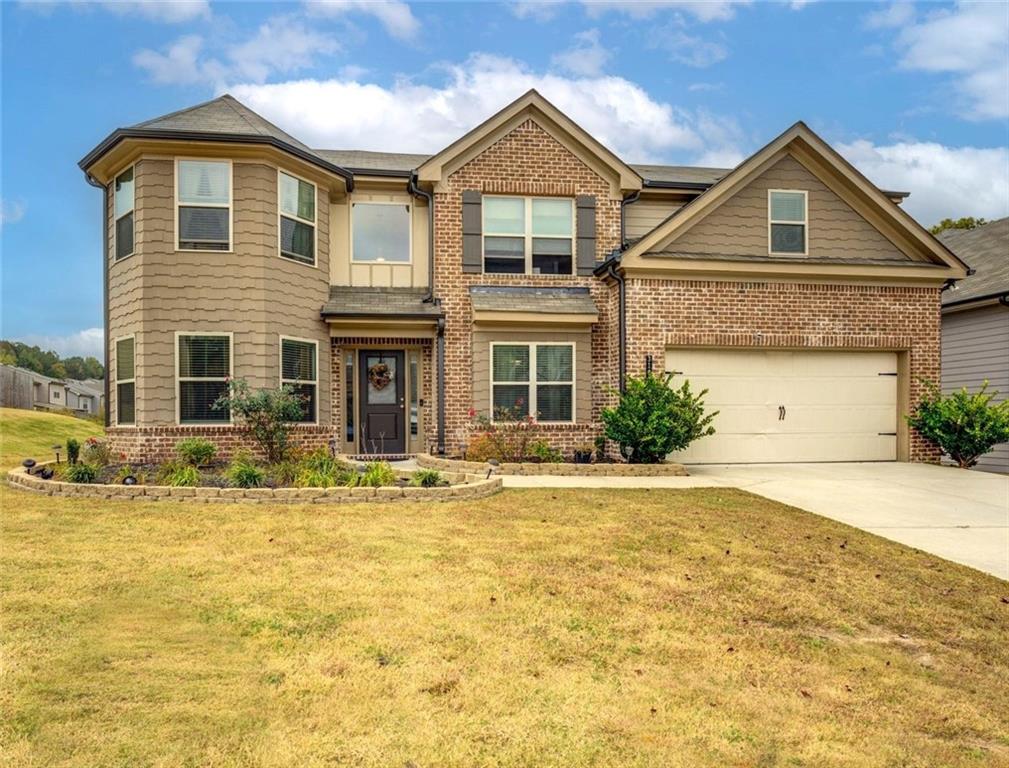 a front view of a house with a yard