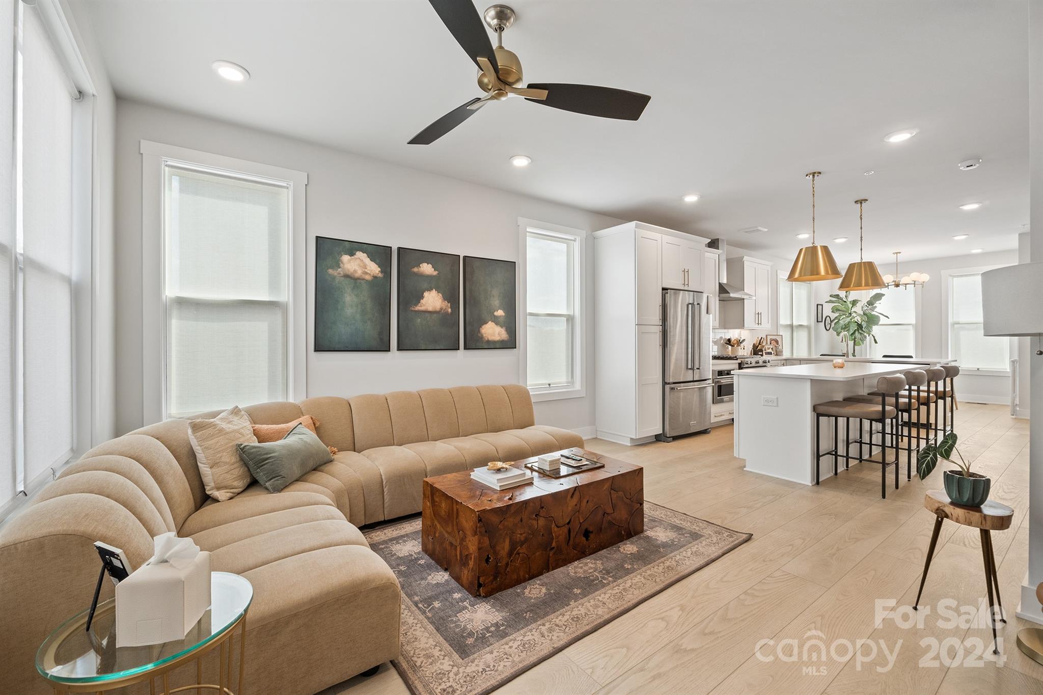 a living room with furniture and kitchen view