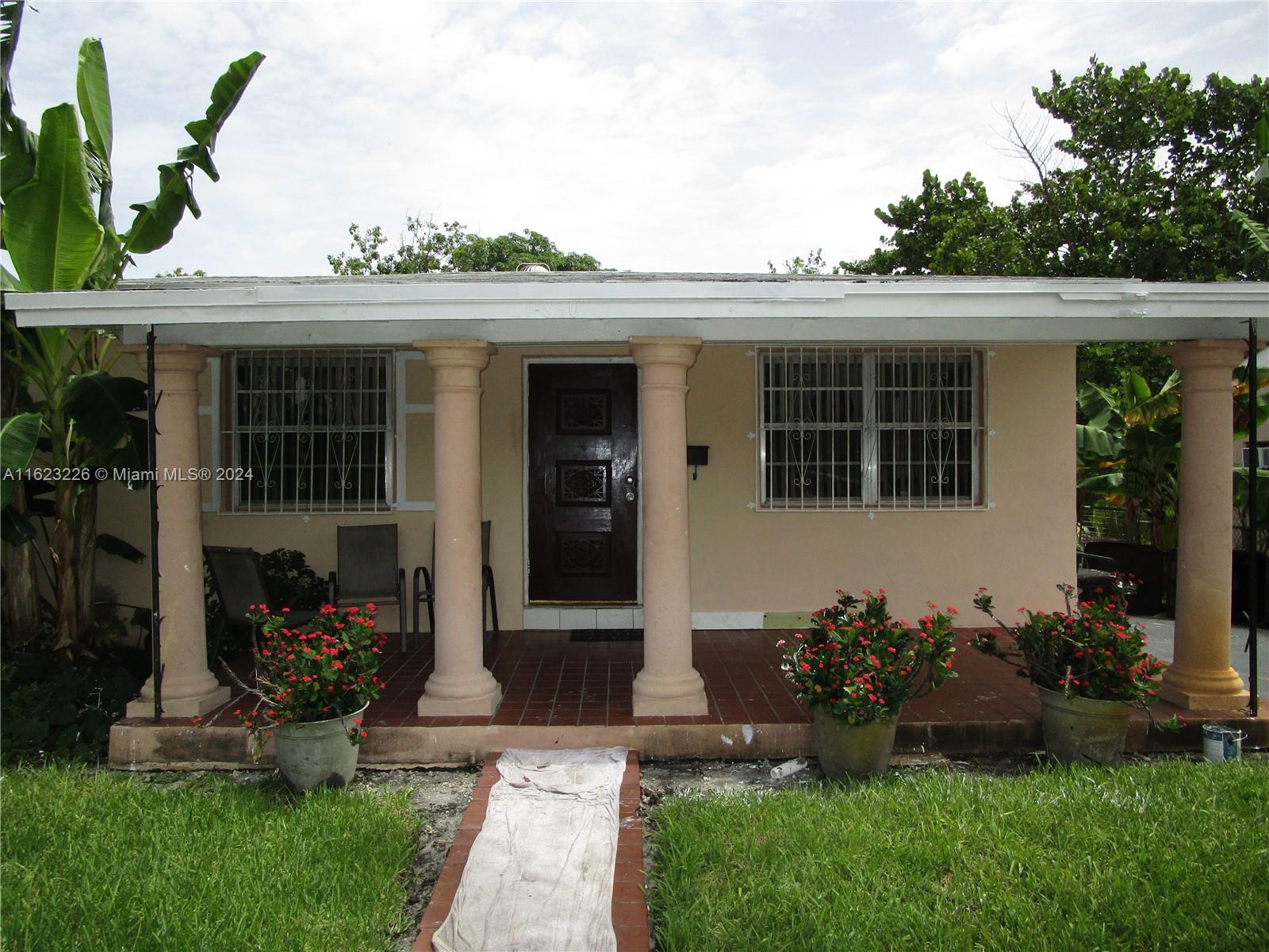 a front view of a house with garden