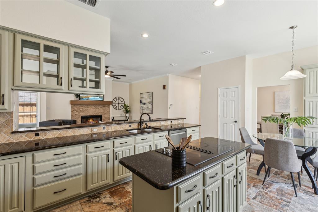 a kitchen with granite countertop a sink and cabinets