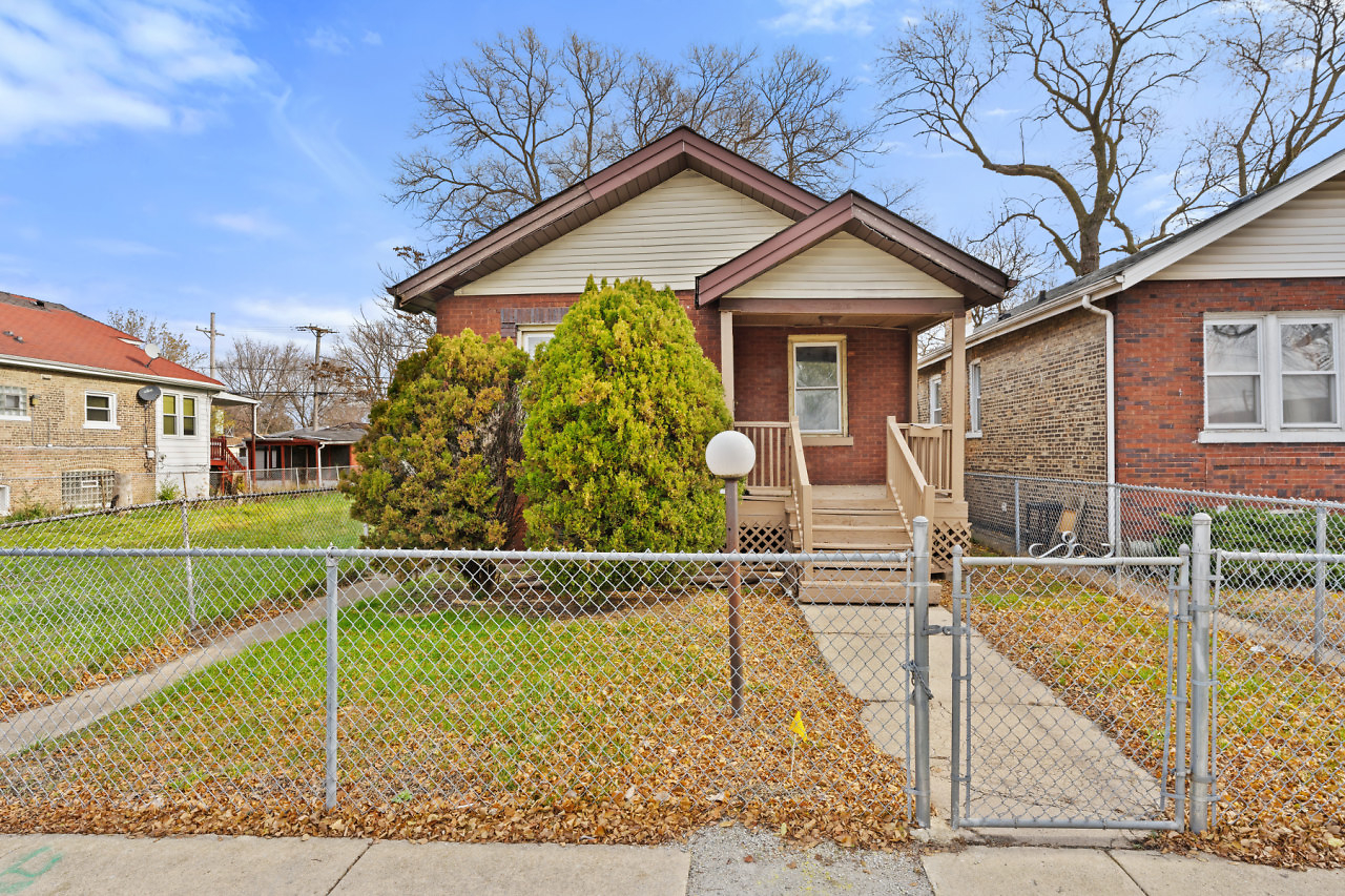 a view of a house with a wooden fence