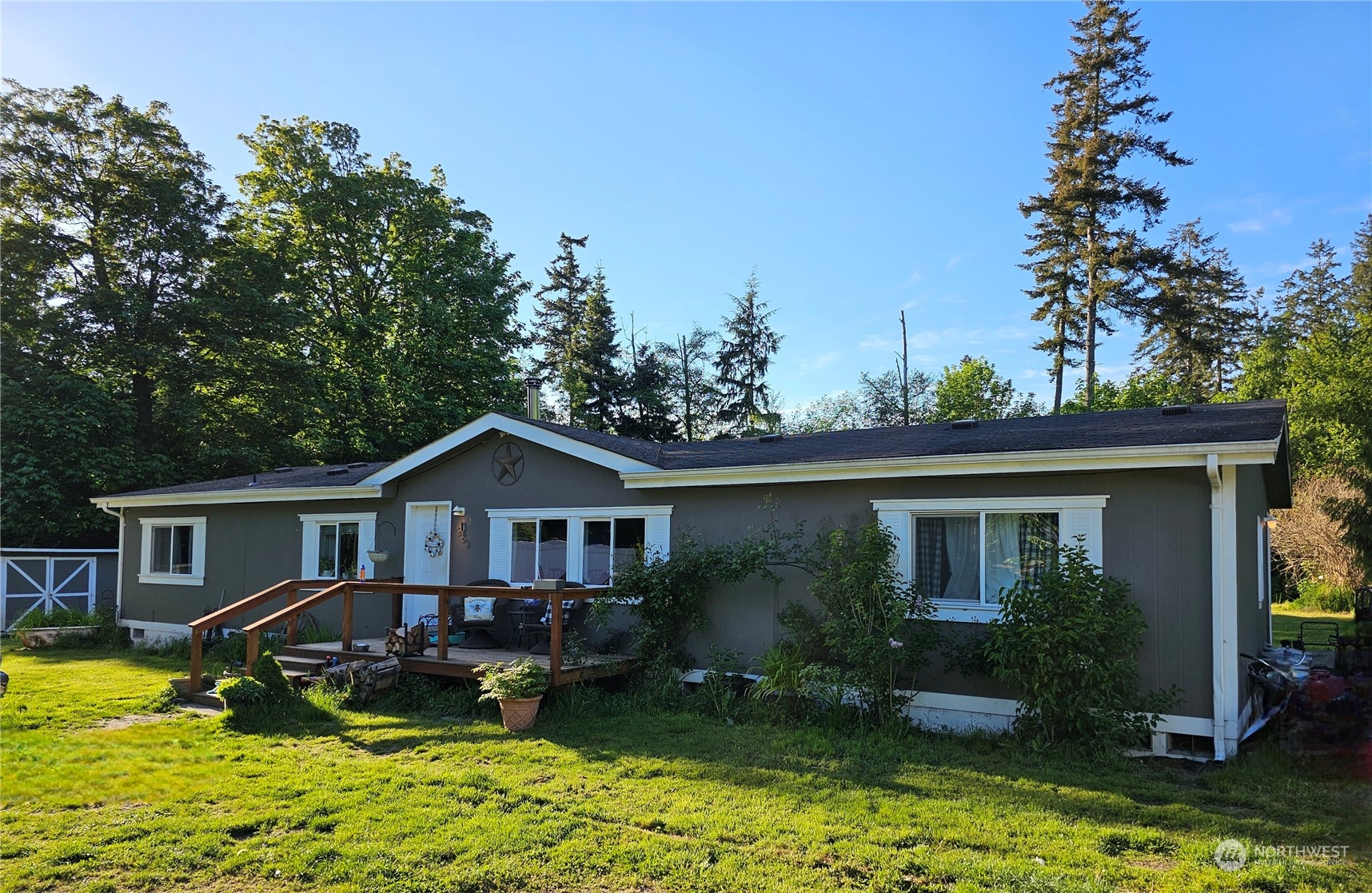 a view of house with garden and swimming pool