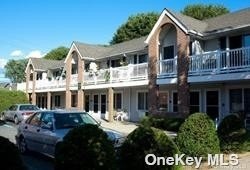 a front view of a residential apartment building with a yard