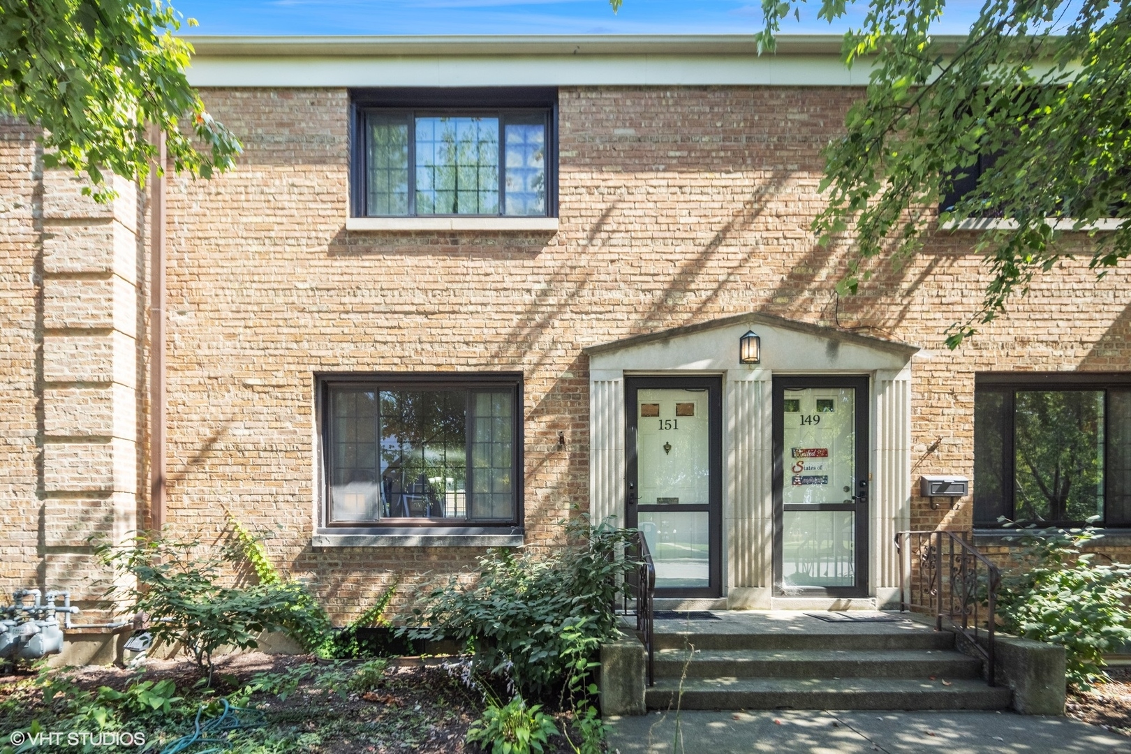 front view of a brick house with a large windows