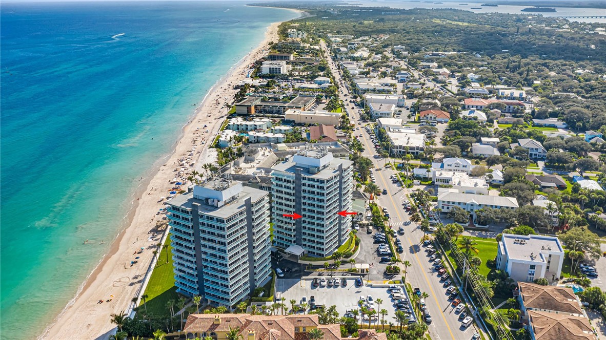 an aerial view of multi story residential apartment building with yard