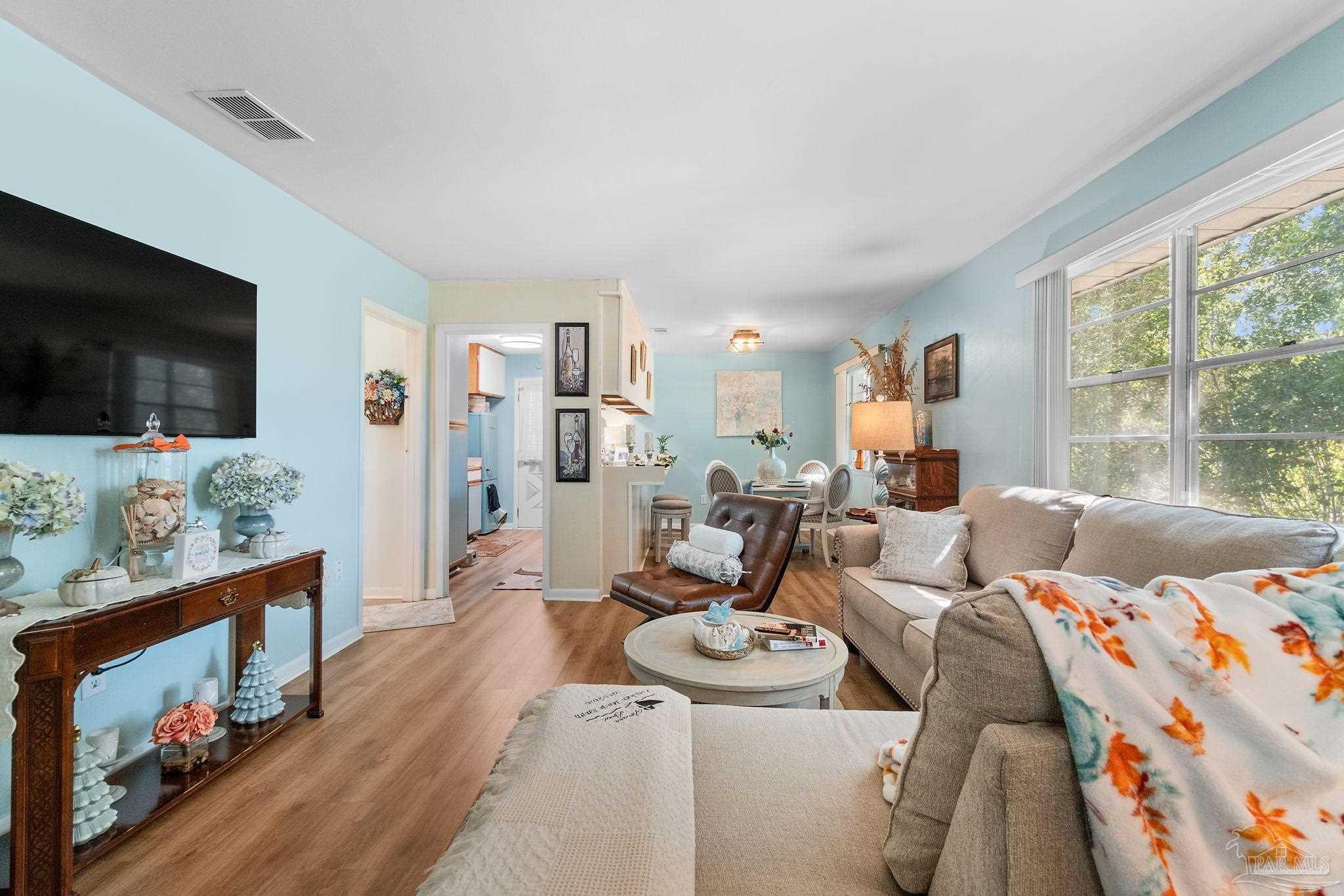 a living room with furniture and a flat screen tv