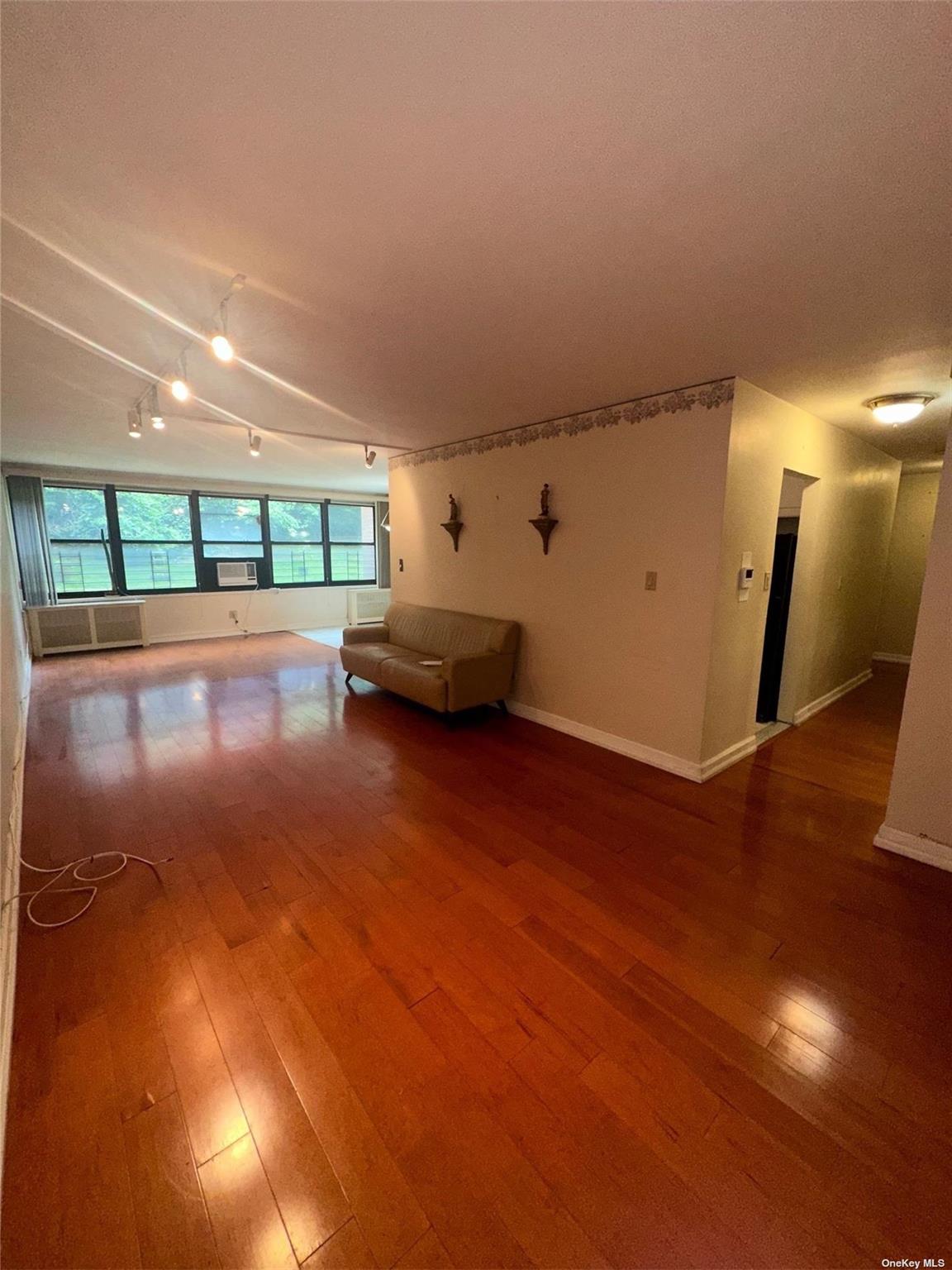 Unfurnished living room featuring hardwood / wood-style flooring