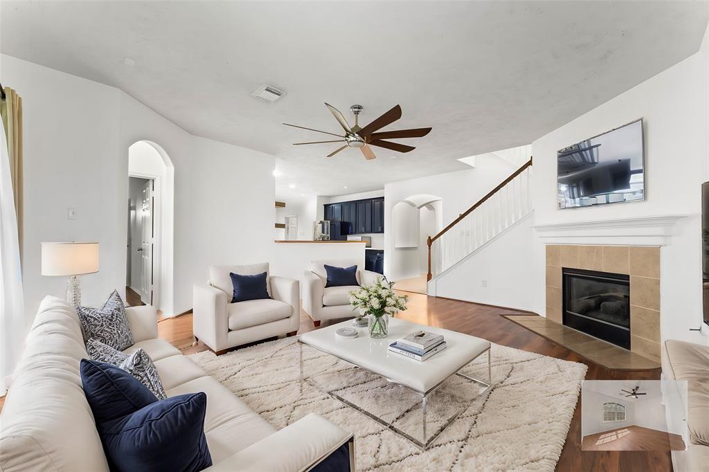 a living room with furniture a fireplace and a flat screen tv