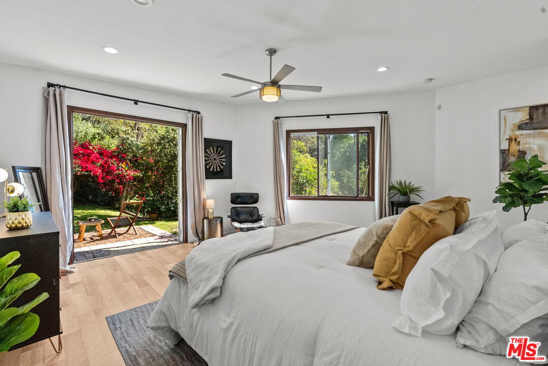 a bedroom with a bed and glass window