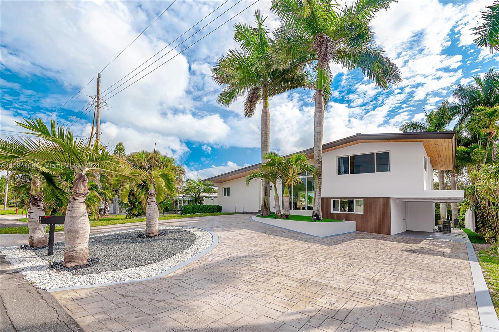 a view of a house with small yard and tree s