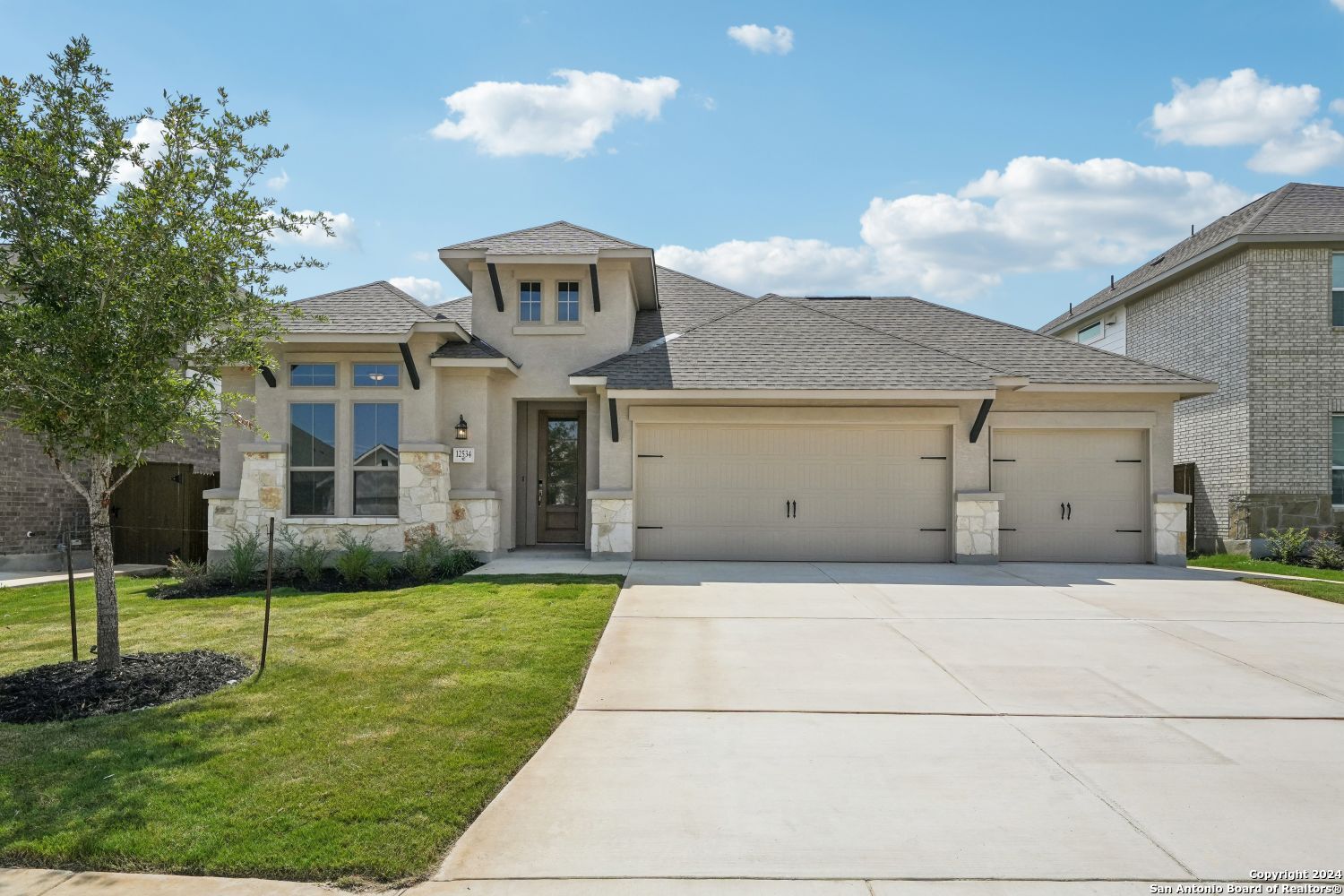 a front view of a house with a yard