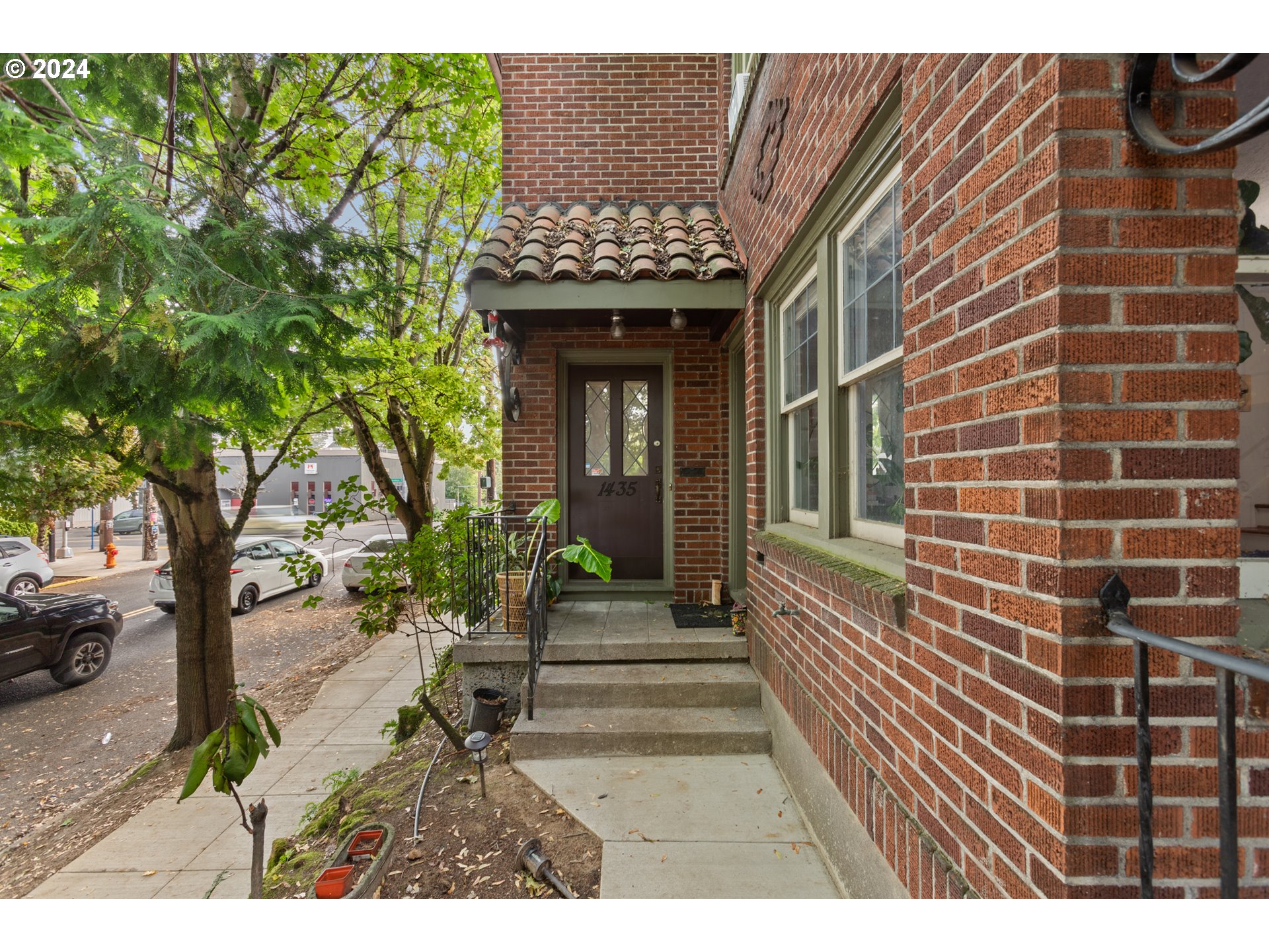 a view of a house with potted plants