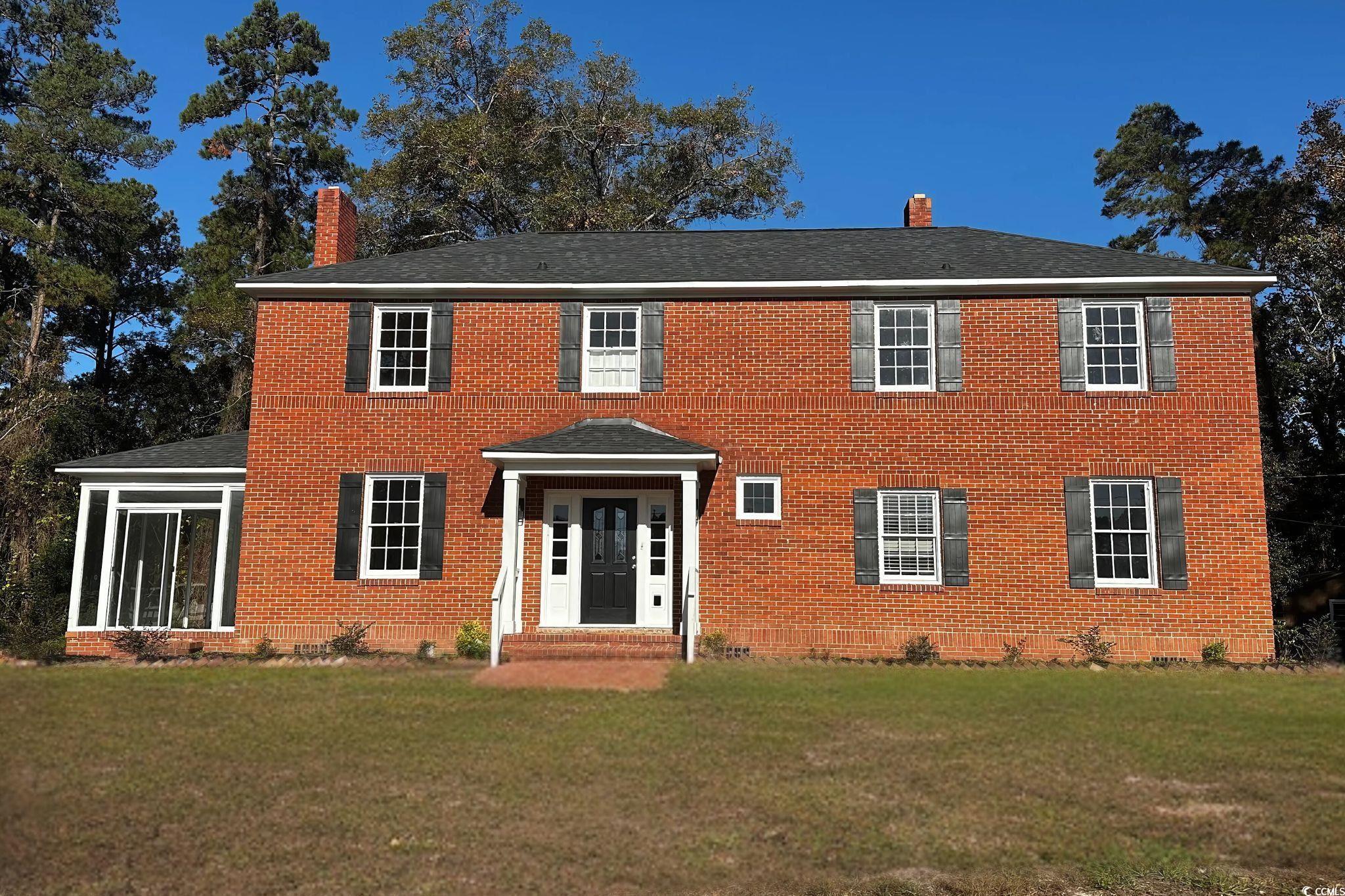 Colonial home featuring a front yard