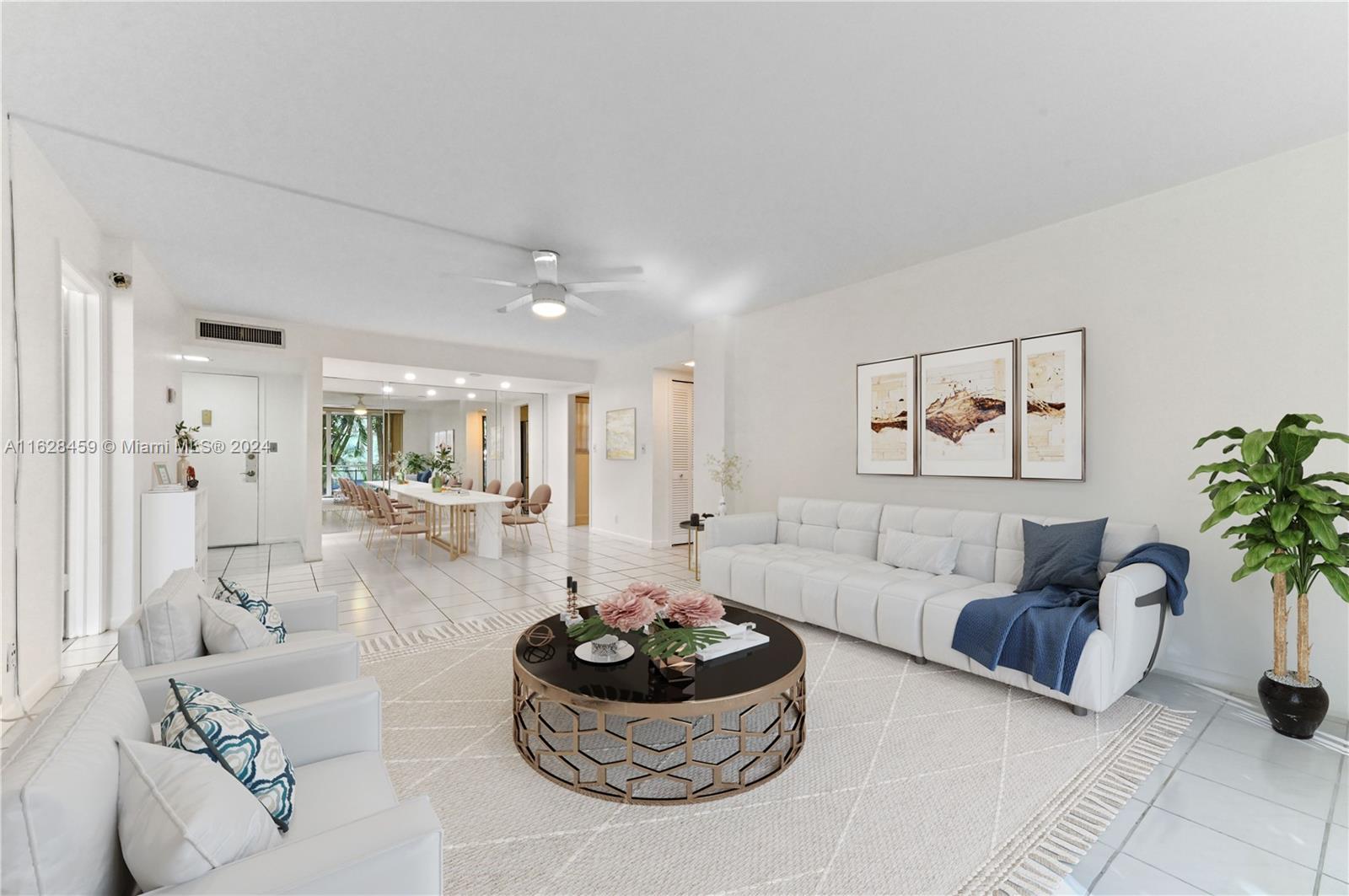 a living room with furniture and a potted plant