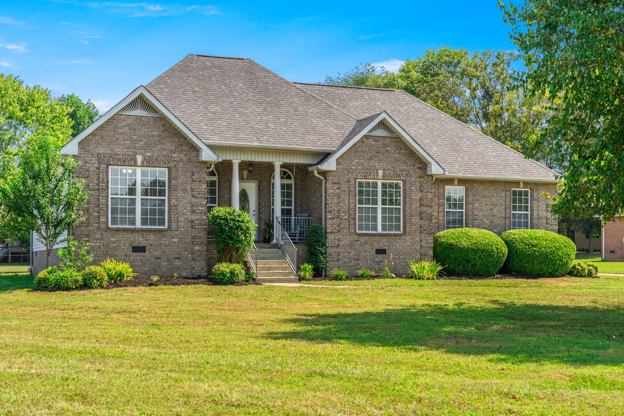 a view of a house next to a yard