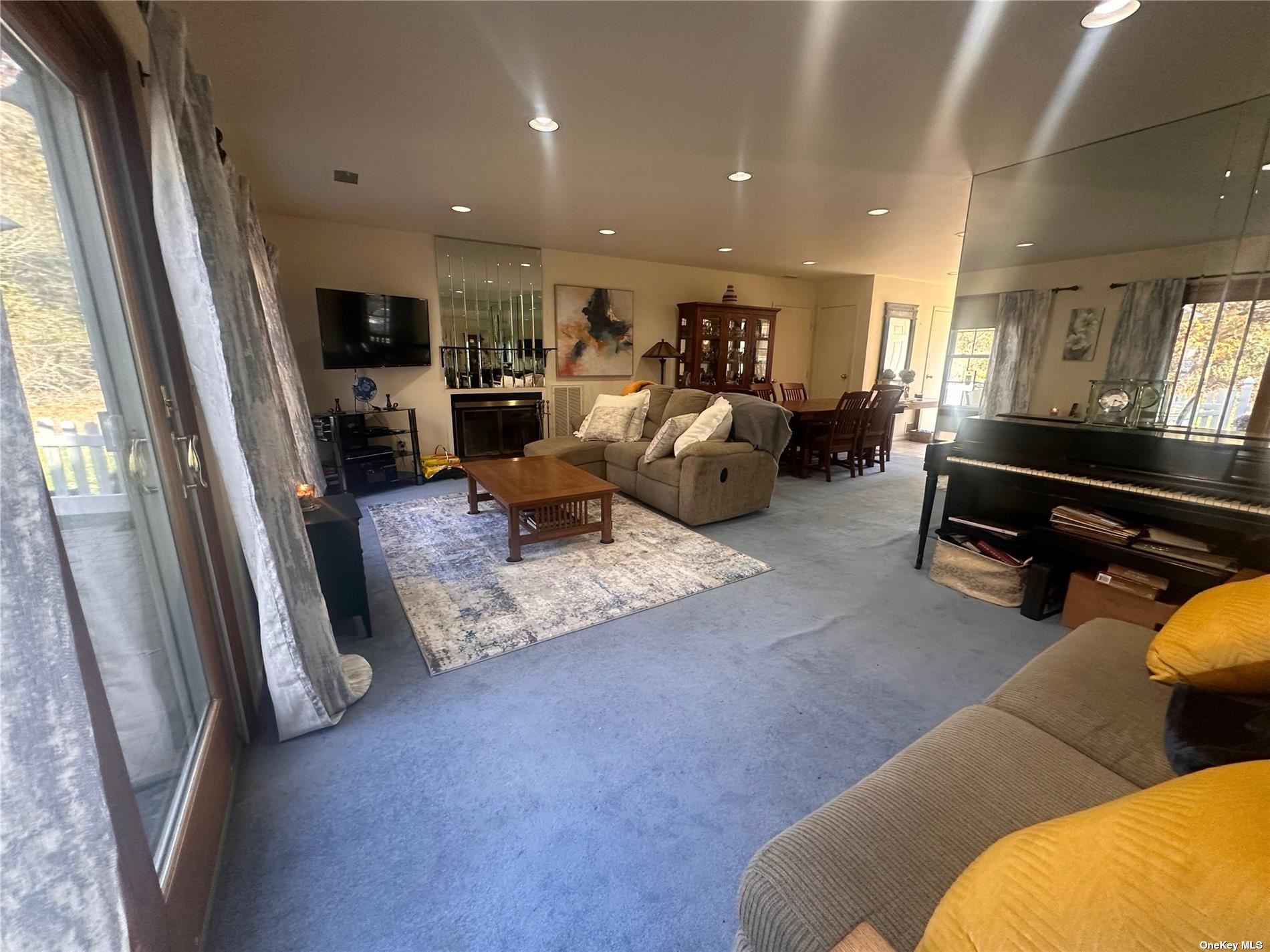 a living room with furniture gym equipment and a large window