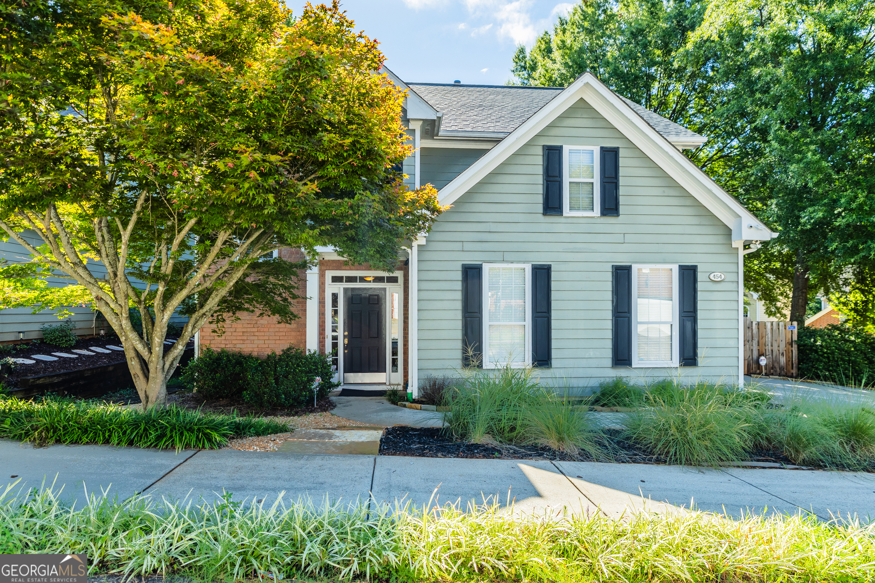 a front view of a house with garden