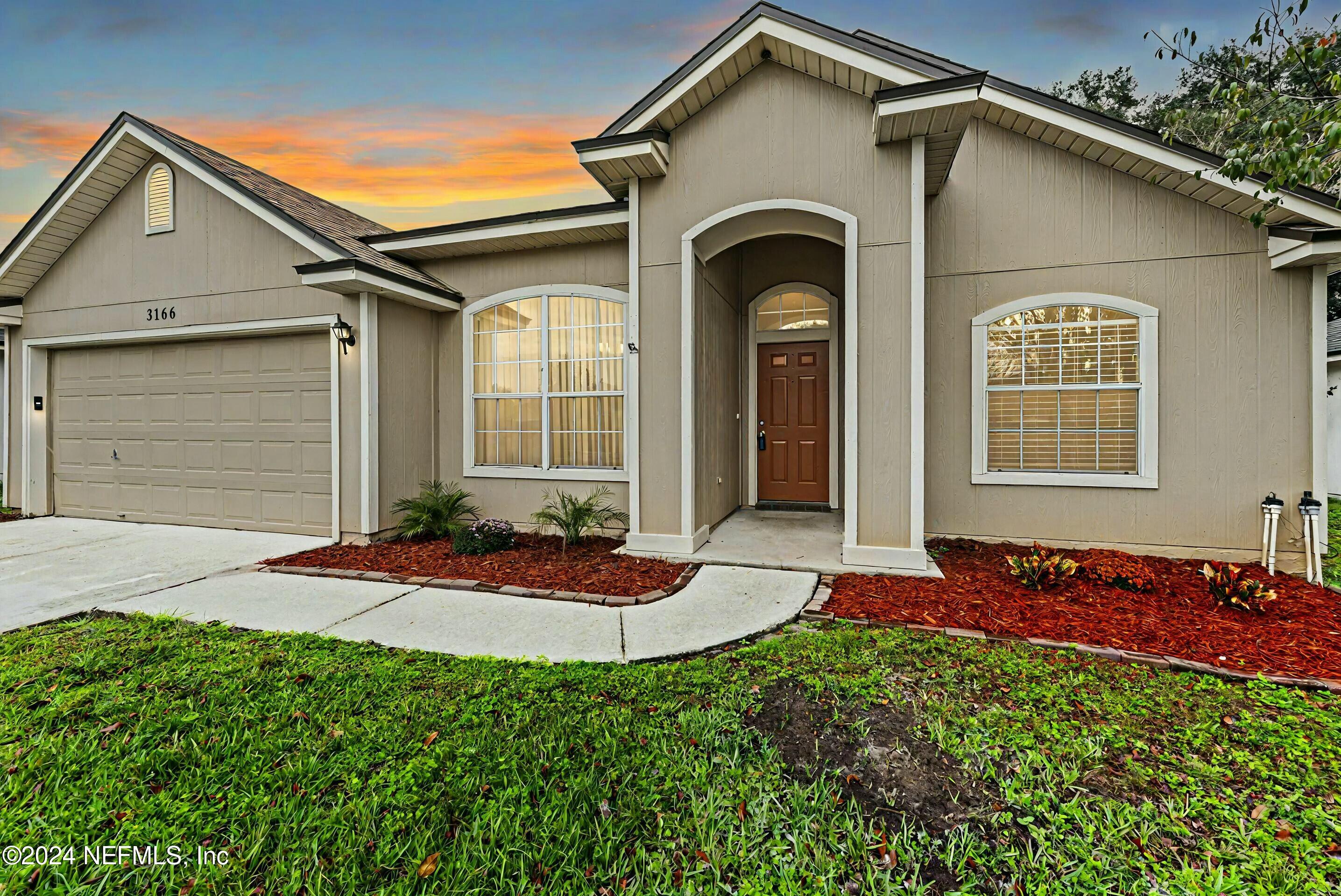 a front view of a house with a yard