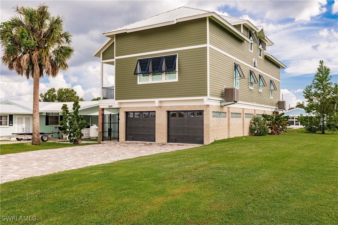 a front view of house with yard and outdoor seating