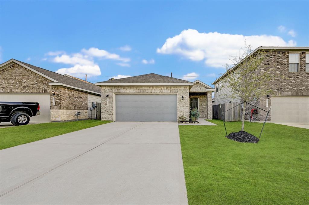 a front view of a house with a yard and garage