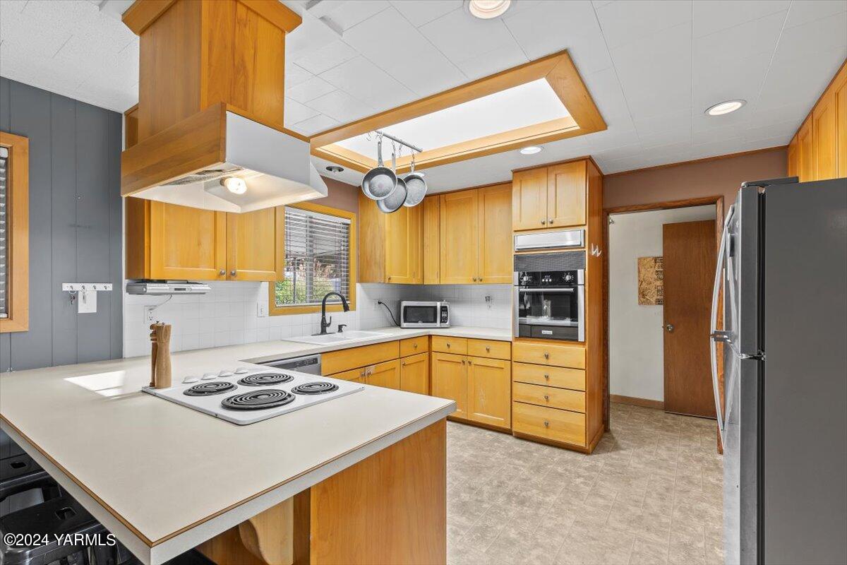 a kitchen with a stove a refrigerator and a sink