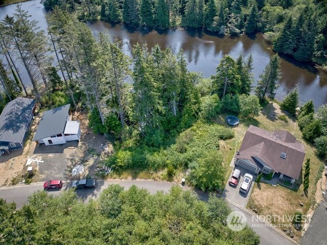 an aerial view of house with yard and lake view