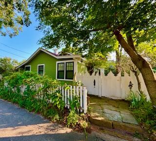 a view of a house with wooden fence