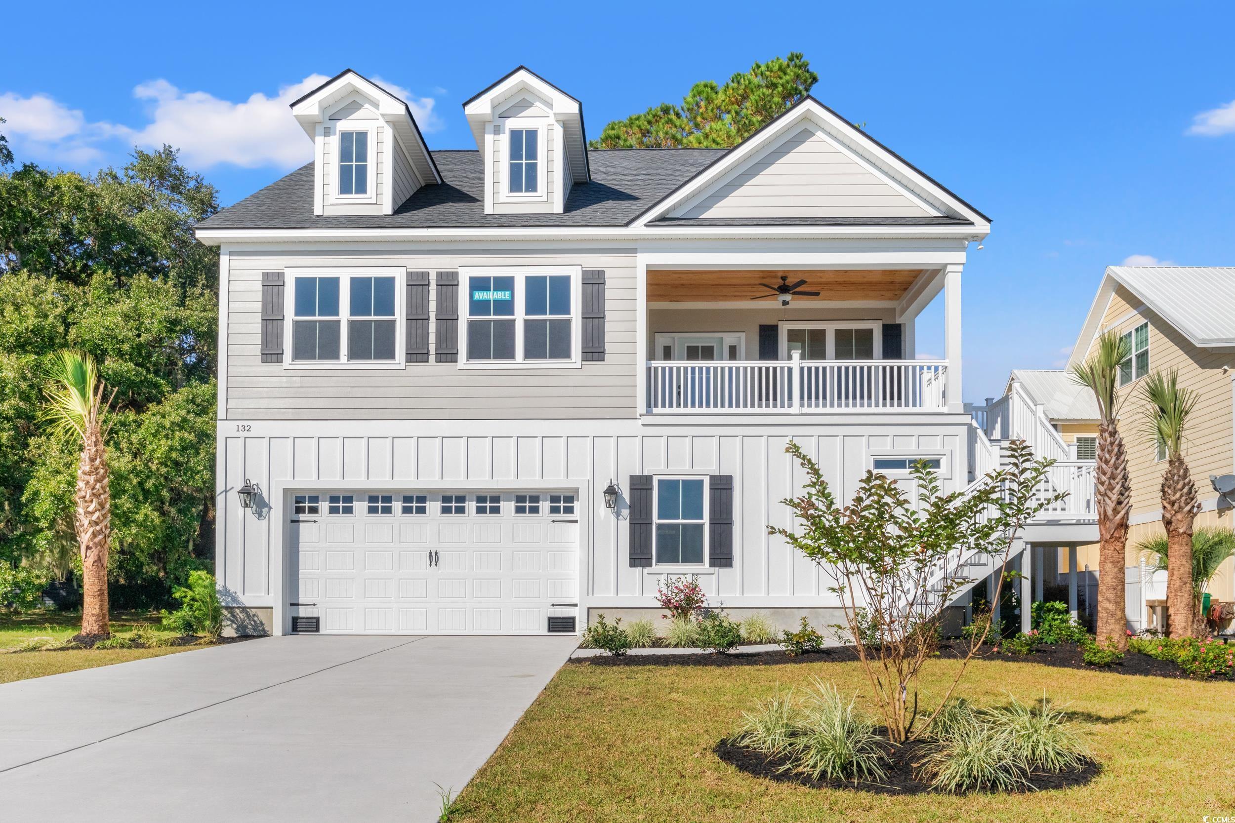 View of front of property with ceiling fan, a balc