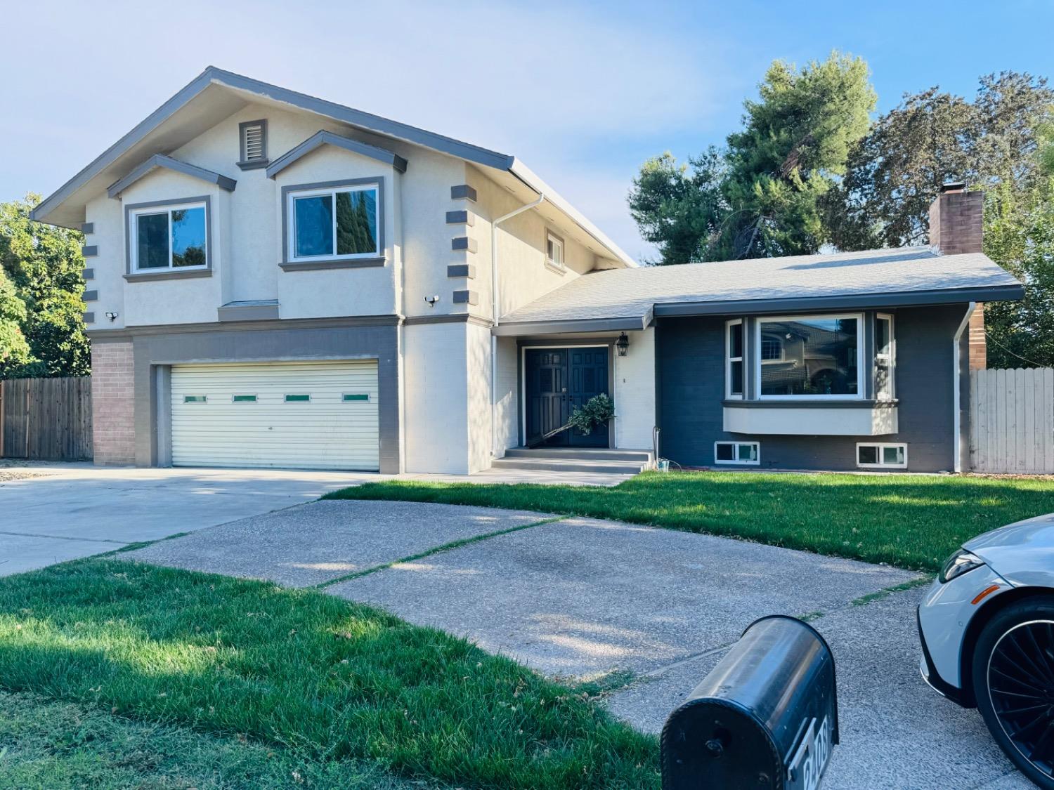 a front view of a house with a yard and a garage