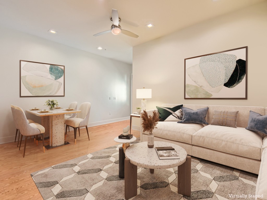 a living room with furniture a rug and a painting on the wall