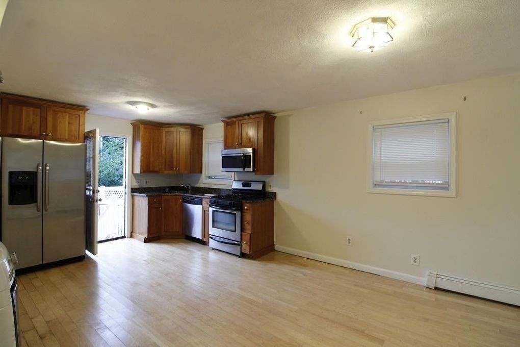 a kitchen with stainless steel appliances a refrigerator and a stove top oven