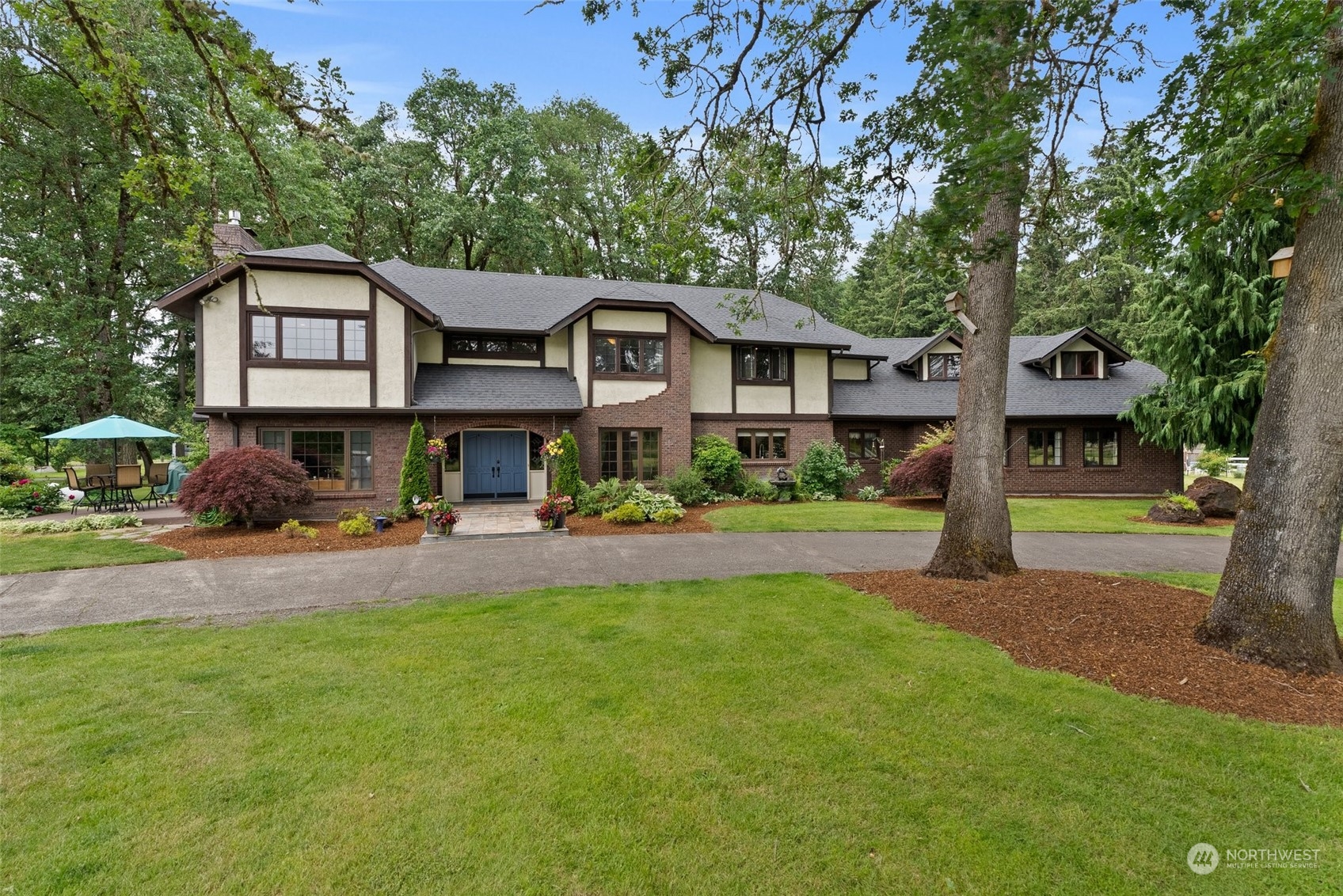 a front view of a house with garden and porch