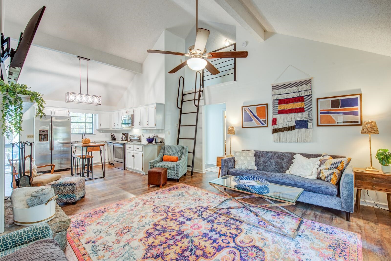 a living room with furniture and a chandelier