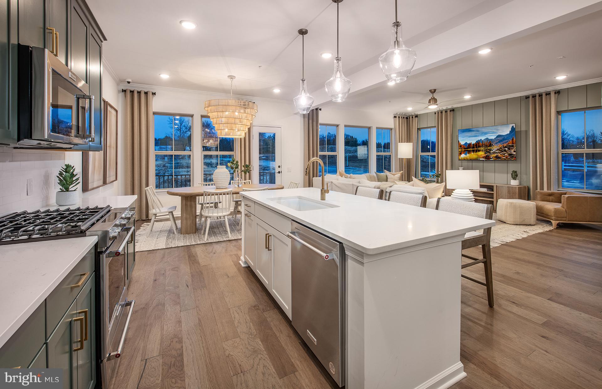 a kitchen that has a lot of cabinets a sink and a stove in it