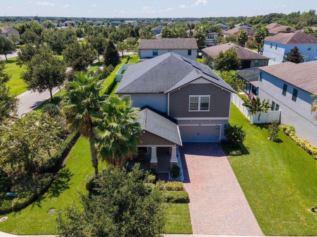 an aerial view of a house with a yard