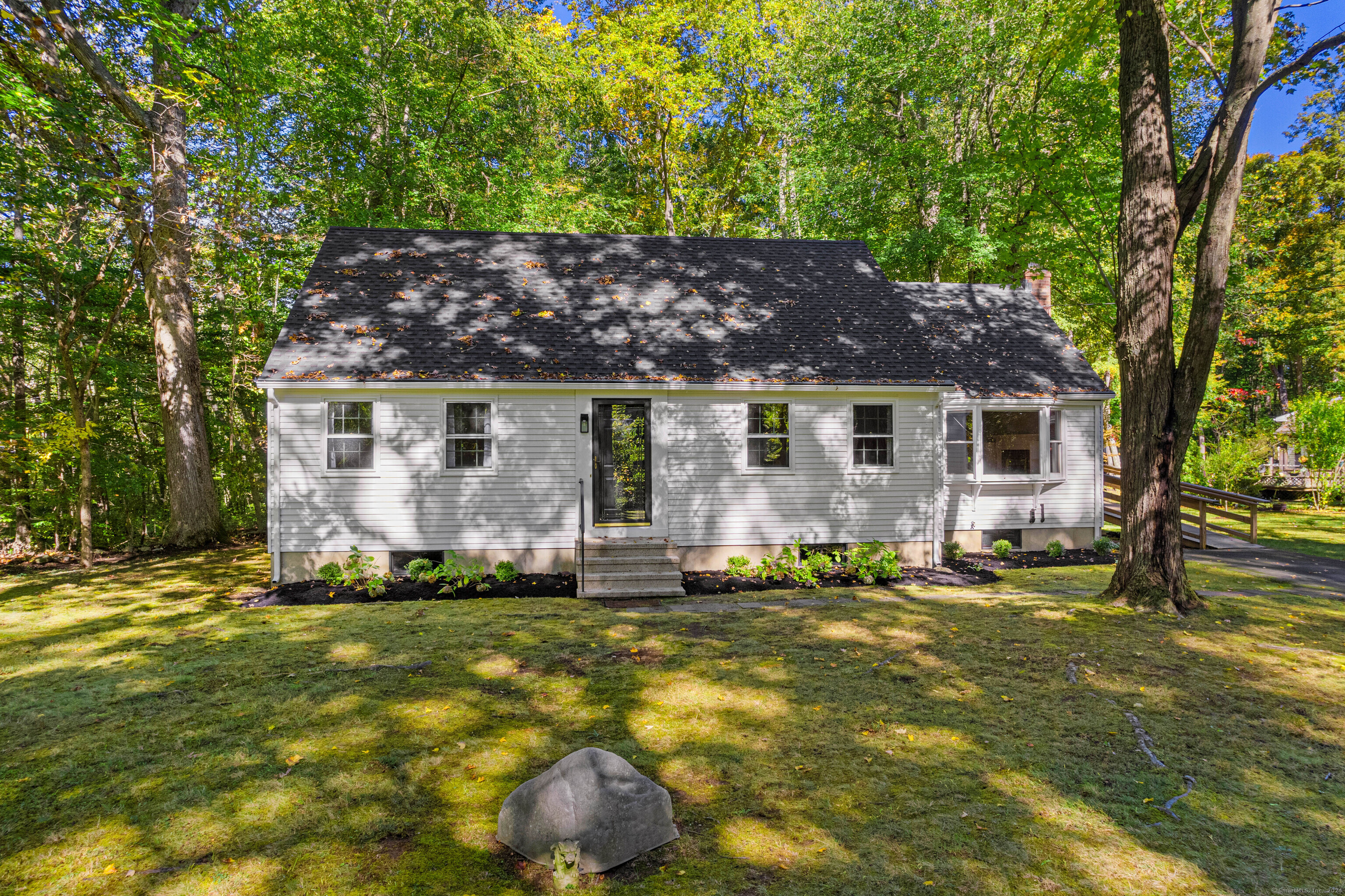 a front view of a house with a garden