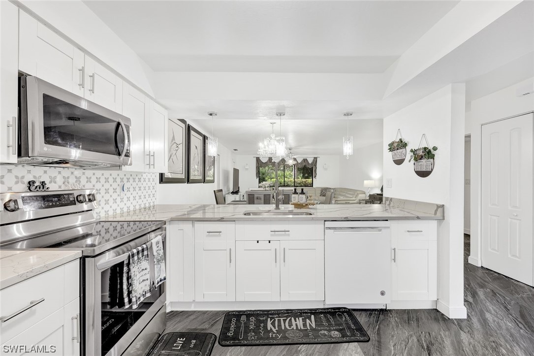 a kitchen with a sink stove and microwave