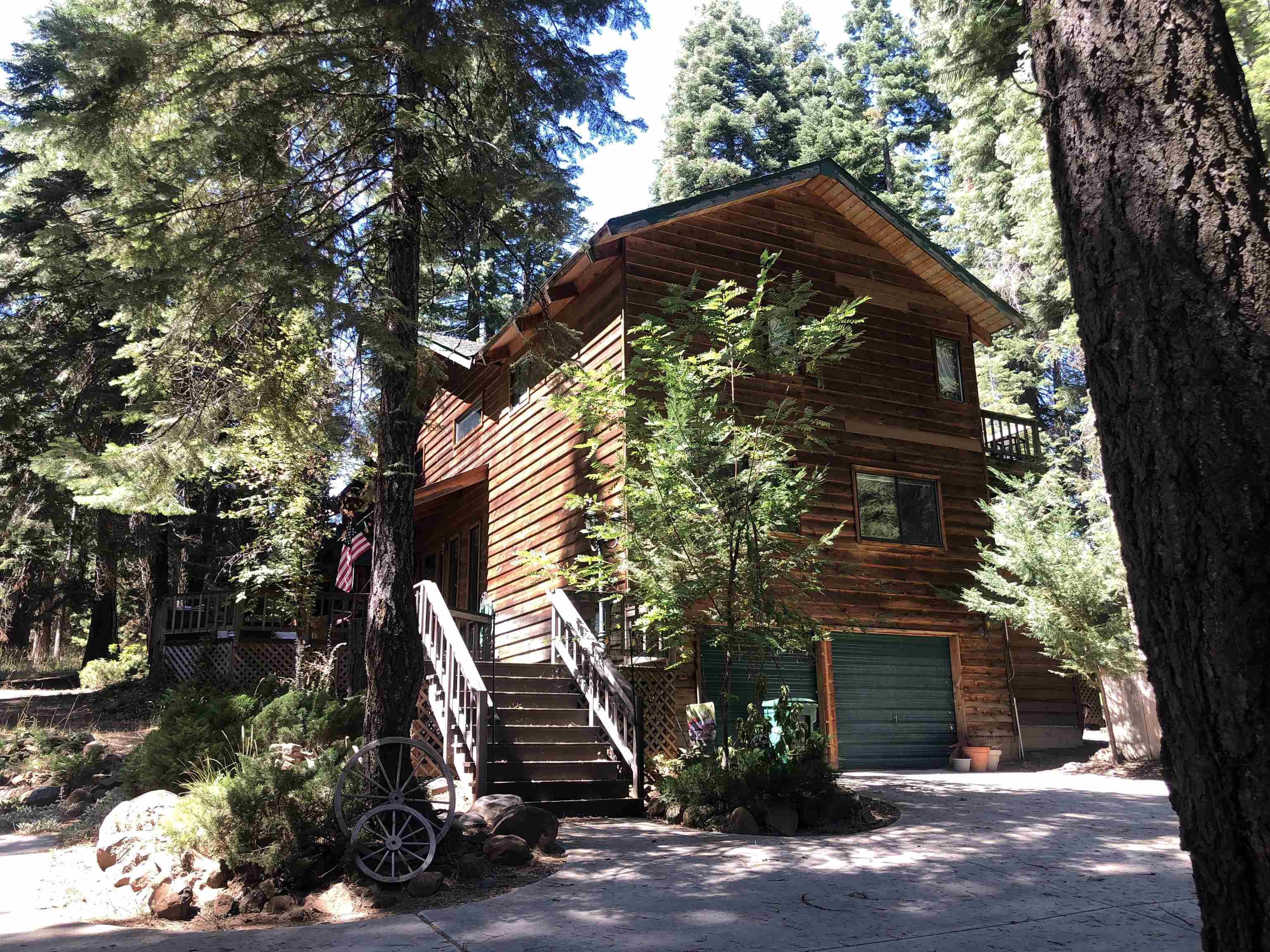 a front view of a house with a tree