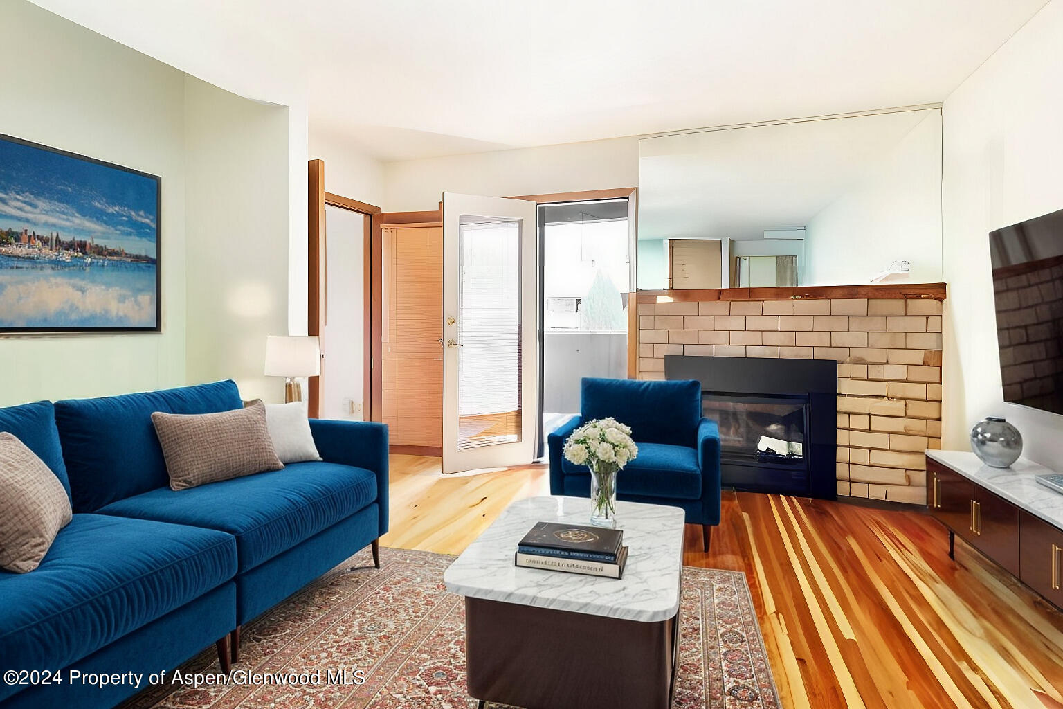 a living room with furniture a fireplace and a table